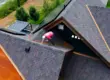 Professional roofer inspects an asphalt shingle roof in Colorado,