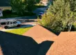 View from a residential rooftop in Littleton, CO showing new asphalt shingles. Replacement made by experts