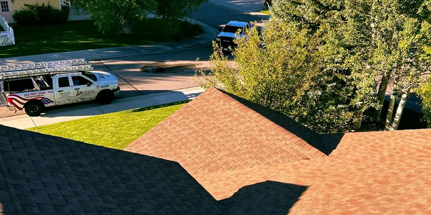 Roof replacement View from a residential rooftop in Littleton, CO showing new asphalt shingles. Replacement made by experts