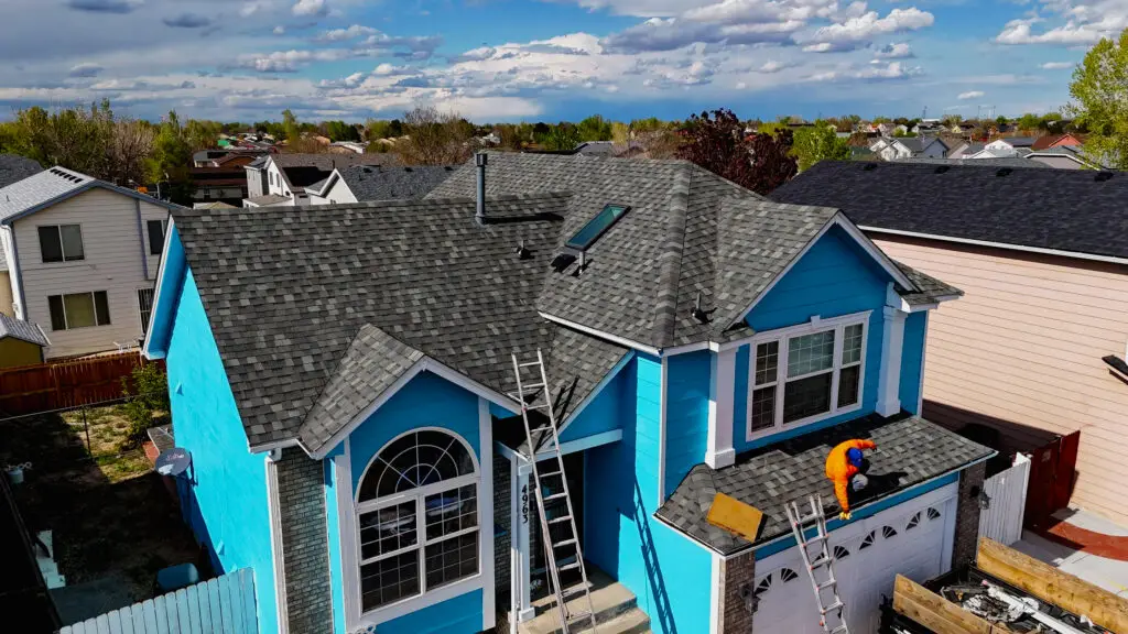 A professional roofer working on roof home in Littleton, CO.