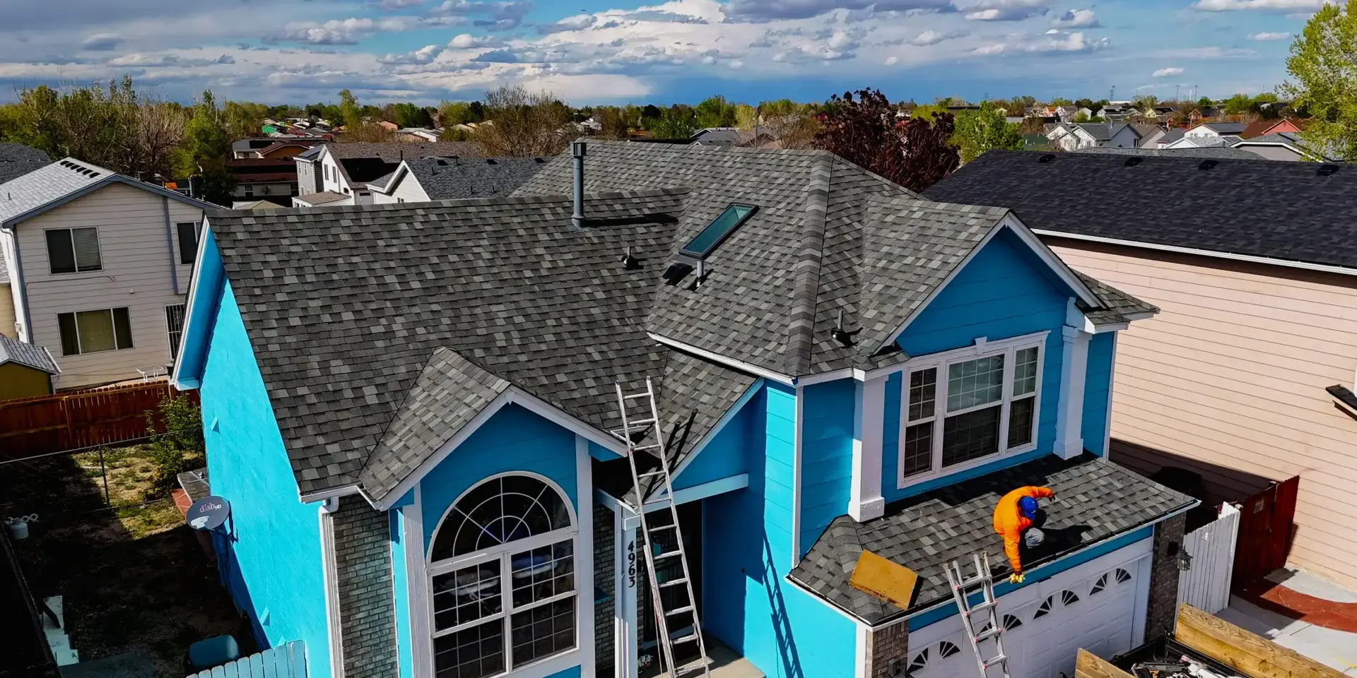 Roof maintenance A professional roofer working on roof home in Littleton, CO.