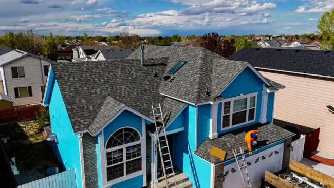 Roof maintenance A professional roofer working on roof home in Littleton, CO.