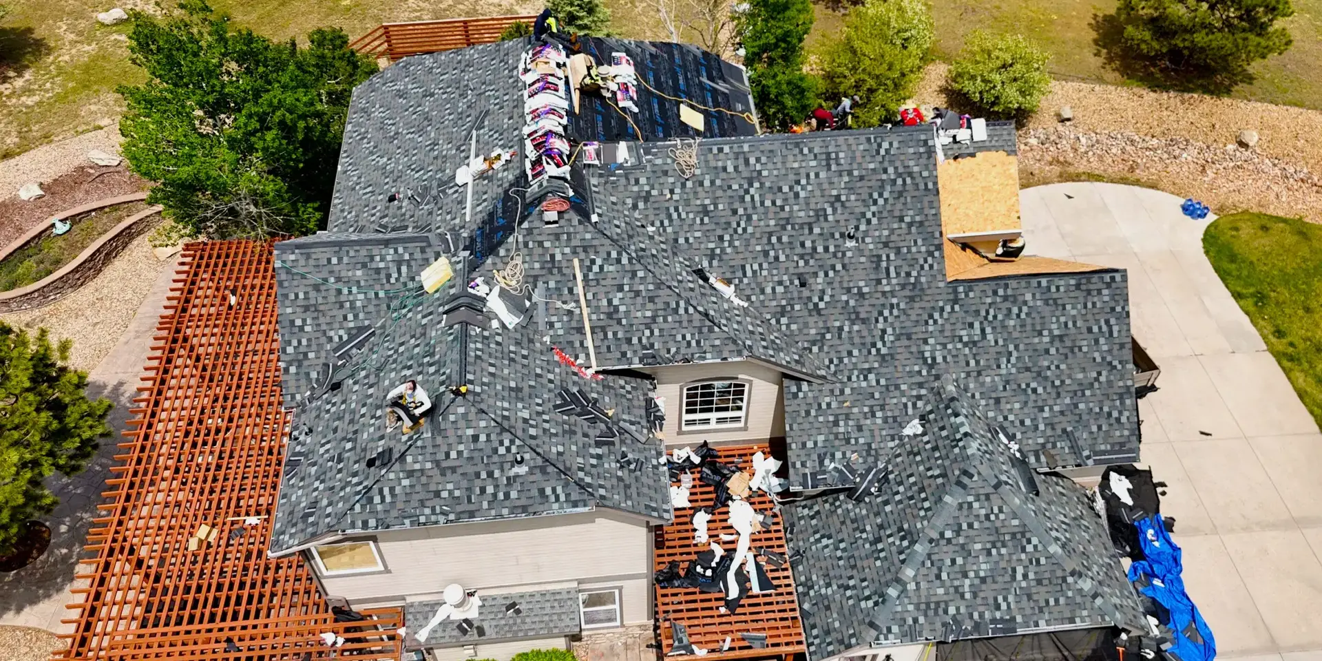 Roof replacement in process Aerial view of a residential roof replacement in progress on
