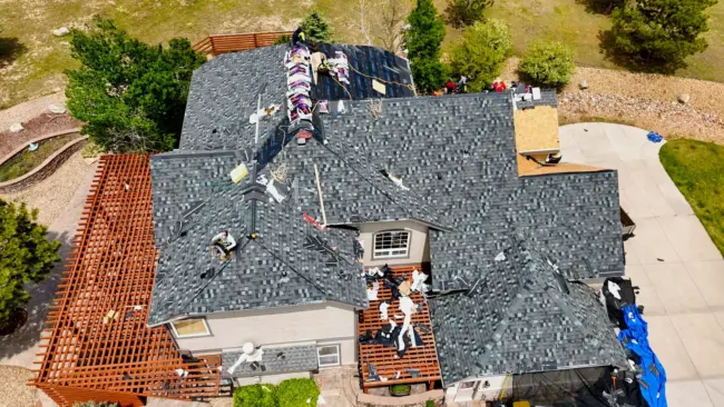 Roof replacement in process Aerial view of a residential roof replacement in progress on