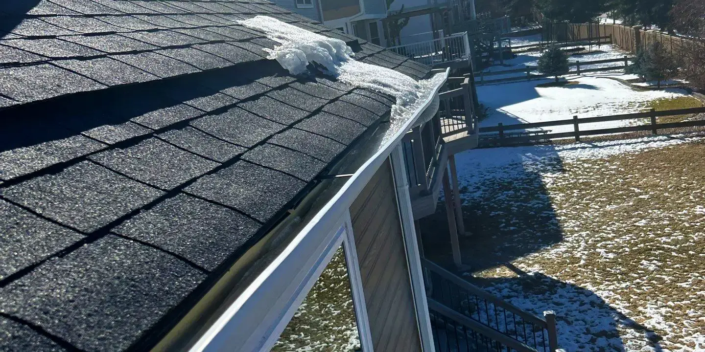 Melting snow Roof in Littleton, CO showing melting snow along the shingles