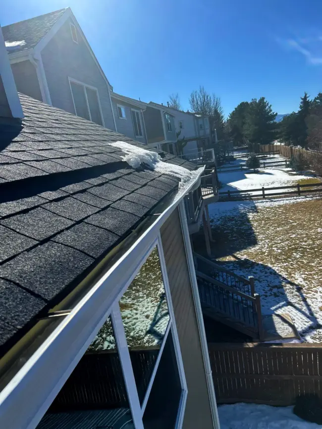 Melting snow Roof in Littleton, CO showing melting snow along the shingles