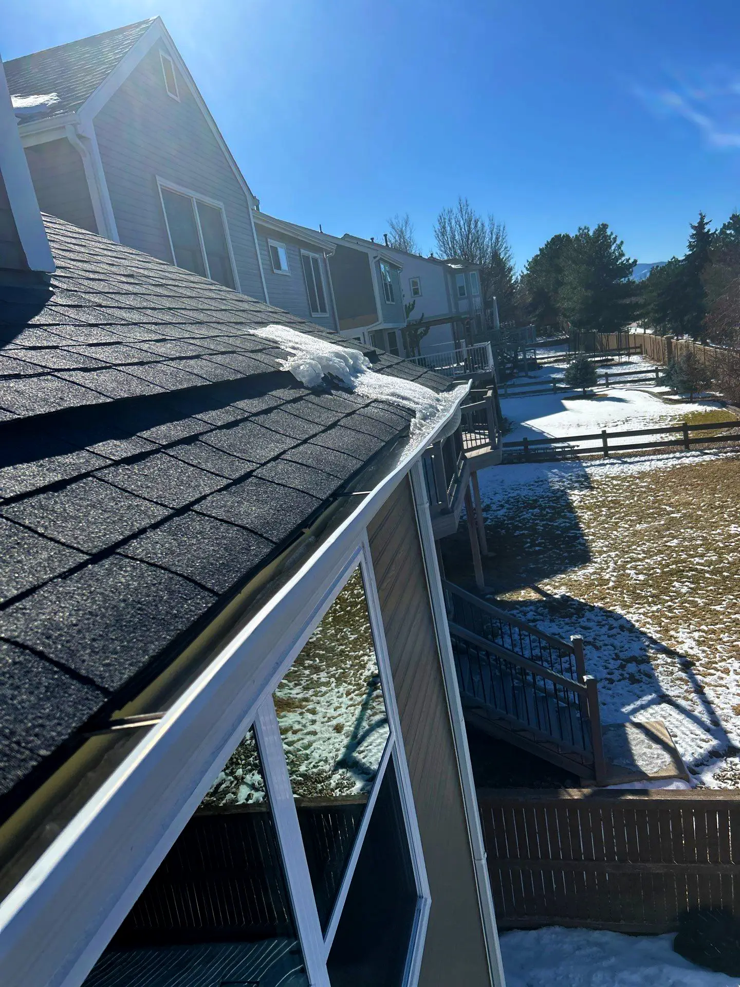 Roof in Littleton, CO showing melting snow along the shingles