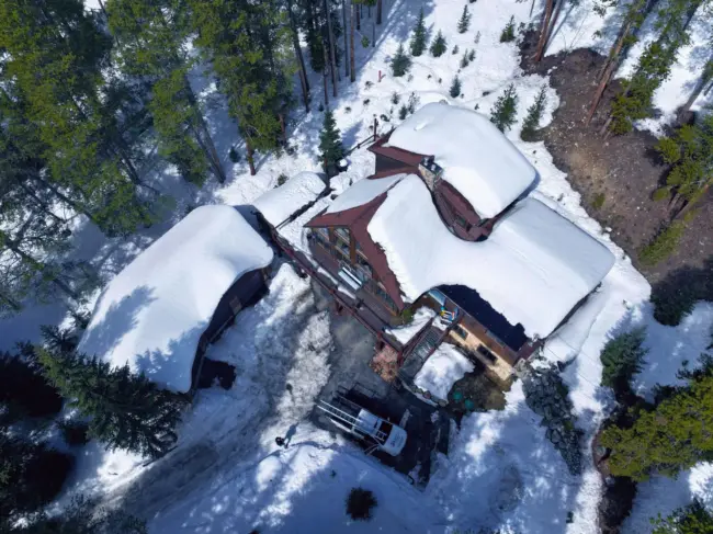 Snow-covered home Aerial view of a snow-covered mountain home