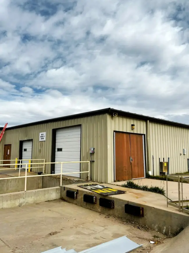 Exterior of an industrial warehouse with a metal roof