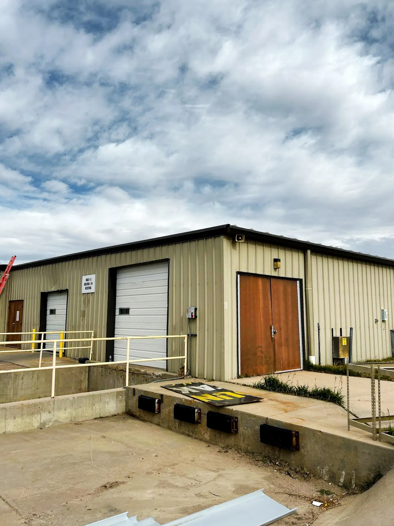 Exterior of an industrial warehouse with a metal roof