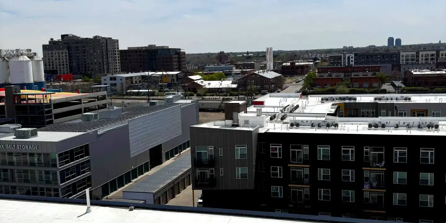 Commercial flat roof View of a large white commercial flat roof with multiple vents and equipment