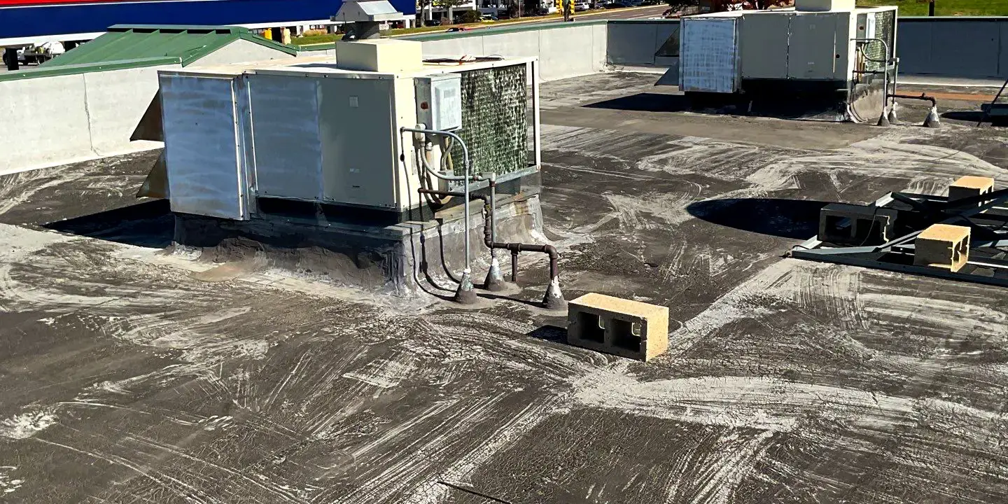 Flat commercial roof Flat commercial roof in Littleton, CO, showing HVAC units and surface wear during maintenance inspection.