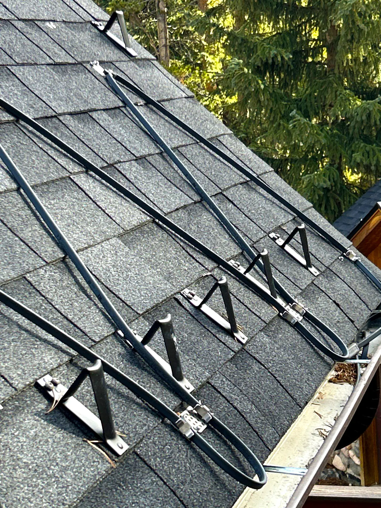 Roof with asphalt shingles and installed Hot Edge Sytem to prevent ice dams in winter.