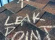 Residential roof shingles marked indicating an active roof leak.