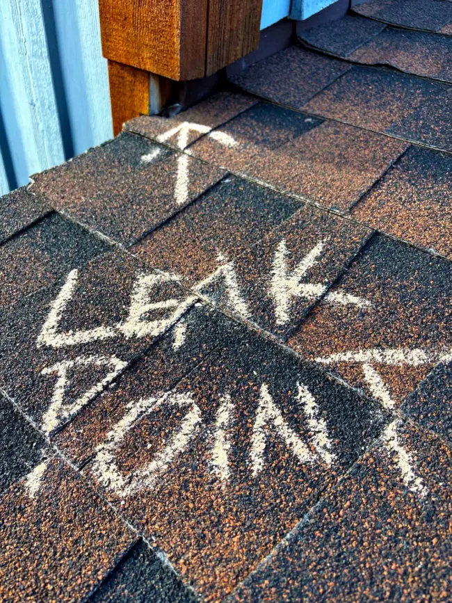 Roof shingles marked indicating an active roof leak. Residential roof shingles marked indicating an active roof leak.