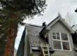 Skilled technicians performing professional roofing work on a residential property, demonstrating expert craftsmanship, proper safety equipment, and high-quality roof installation.