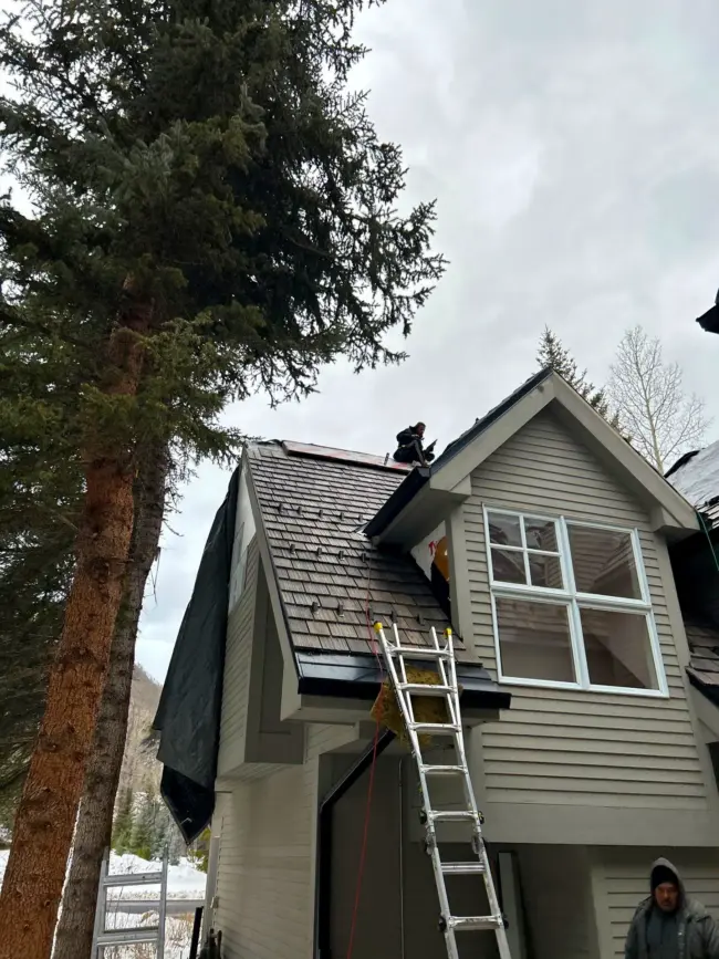 Skilled technicians performing professional roofing work on a residential property, demonstrating expert craftsmanship, proper safety equipment, and high-quality roof installation.