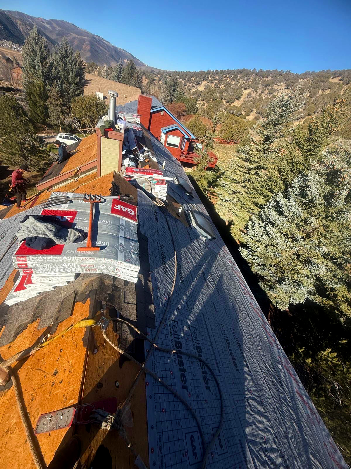 Residential roof installation in a mountainous area of Colorado, showing underlayment and roofing materials applied by experts during a roof replacement project.