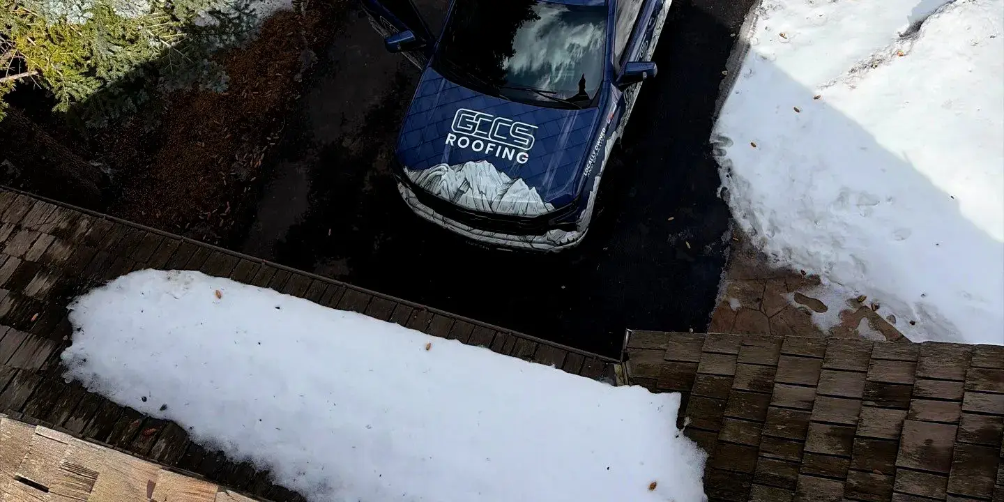 GCCS Roofing truck GCCS Roofing truck parked in a snowy driveway in Littleton, CO while a roofer performs a roof inspection