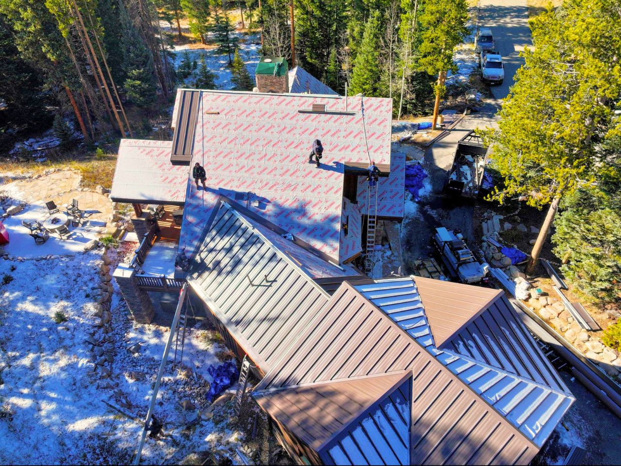 Metal roof installation progress Colorado mountain winter