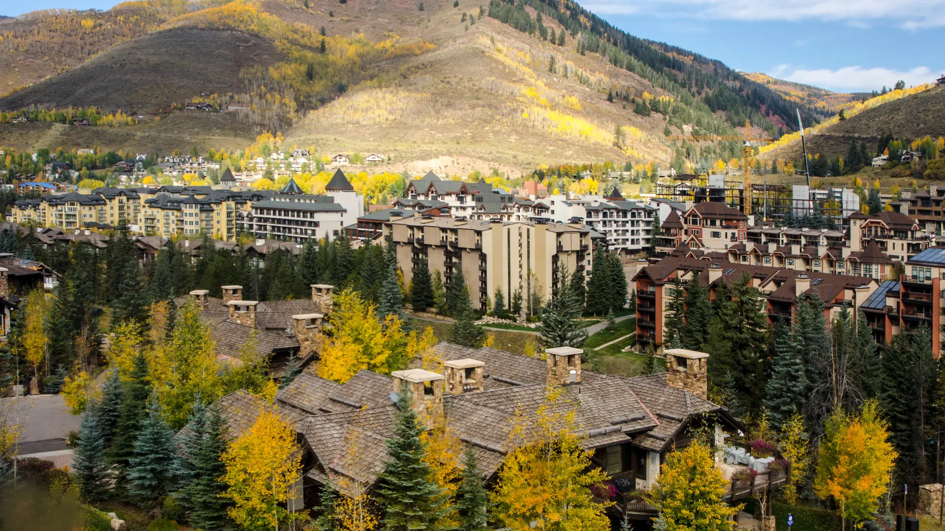 Aerial Vail Valley rooftops fall colors mountain backdrop