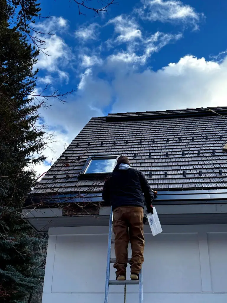 Professional roof inspection on a steep residential roof in Avon, CO by a local roofing contractor